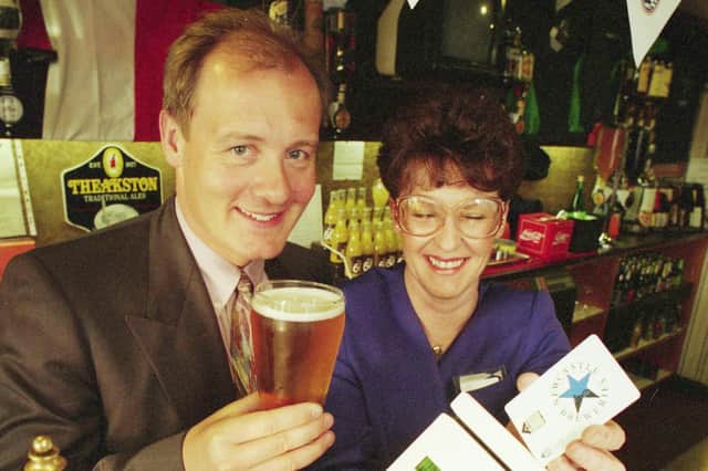 John Hedley prepares to savour the Ashbrooke's best lager by paying by card, with landlady Cathy Redpath looking on in 1994.