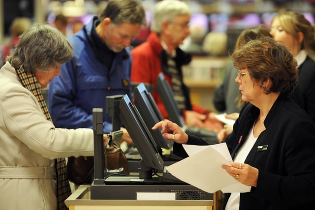 Customers queue at the busy tills at John Lewis, Sheffield, in 2008