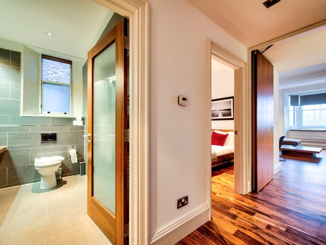 The hallway gives you an idea of the overall look and feel of the flat, with white walls, big windows and contemporary wooden flooring.