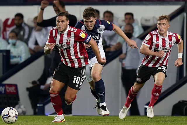 West Bromwich, England, 18th August 2021.  Dara O'Shea of West Bromwich Albion chases Billy Sharp of Sheffield Utd during the Sky Bet Championship match at The Hawthorns, West Bromwich. Picture credit should read: Andrew Yates / Sportimage