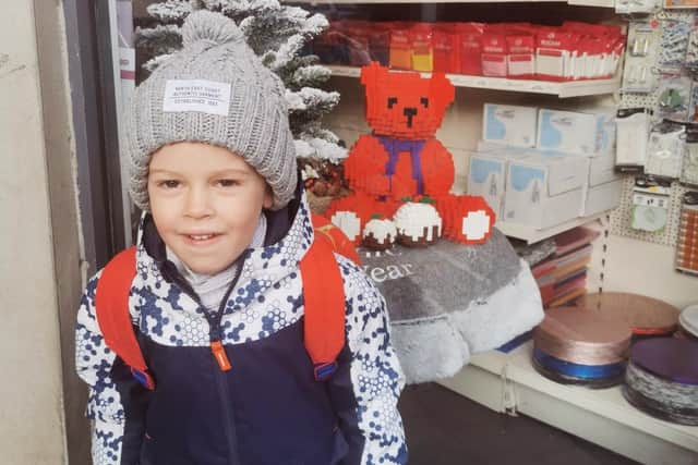 One of the children who took part in the trail outside The Cake Shop on Holme Lane with his favourite bear.