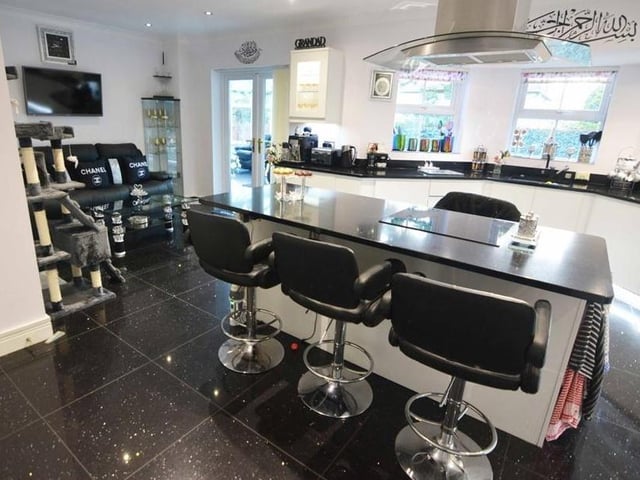 The kitchen doubles up as a family room with space for furniture to suit a range of uses. An integrated set of appliances includes a dishwasher and a double oven with a countertop hob and overhead extractor hood. French doors lead to the conservatory.