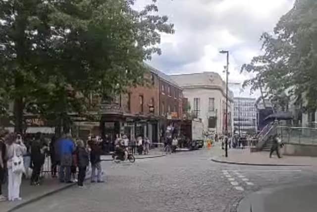 An image from Star reader Andrew Nurse's video of The Full Monty TV series crew filming in Sheffield city centre today - crowds of passers-by are kept back by barriers
