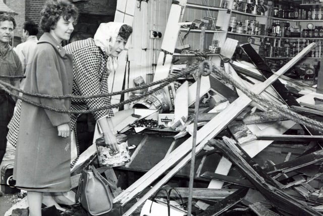 Owner of the shop, Mrs Margaret Brooks (left) and assistant Mrs Norma Betts, survey the damage to the frontage of their Penistone Road Shop, August 22, 1961