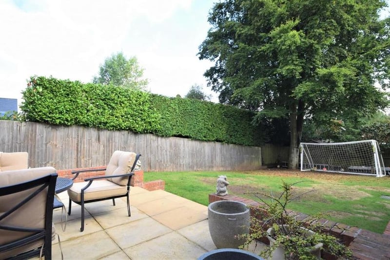 Just beyond the patio area is this back garden. The lawn is an ideal play area, in view of the house and secured by a surrounding fence.