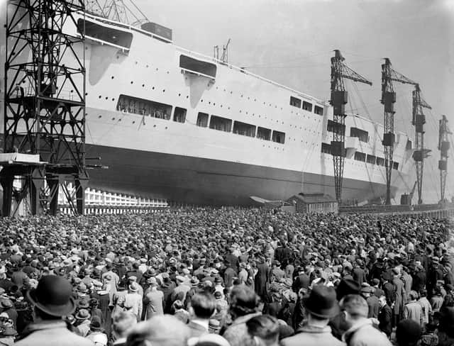 Crowds watch as the 22,000 ton aircraft carrier HMS Ark Royal (91) is launched at the Cammell Laird shipyard in Birkenhead, 13th April 1937. The ship was later sunk off Gibraltar by the German submarine U-81 in November 1941. (Photo by Hudson/Topical Press Agency/Hulton Archive/Getty Images)