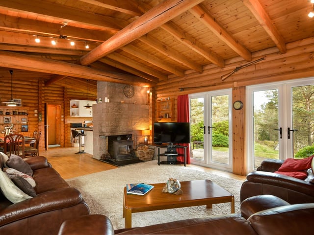 Large windows ensure the living area gets lots of light and bring the outdoors inside