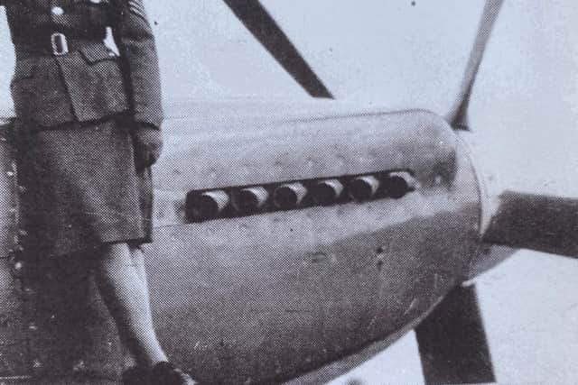 Katherine Crookes in uniform on a plane wing.