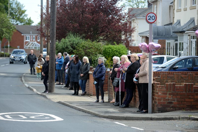 Funeral procession for Monkton Village store Gladys Stonehouse as mourners gather on the street.