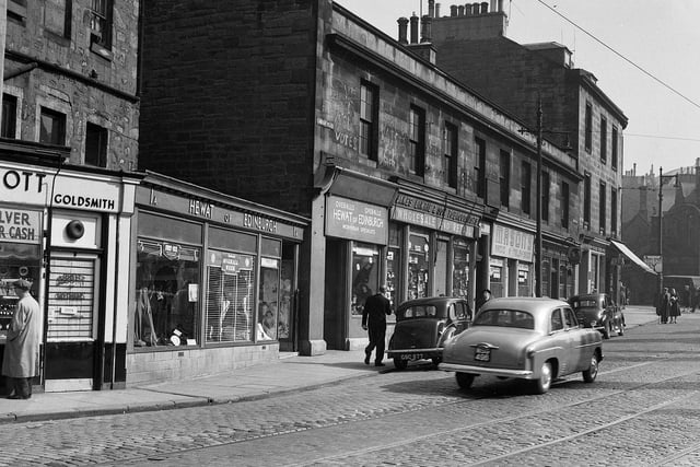 Buildings at the corner of Chambers Street and Lindsay Place in April 1956 which were demolished to make way for the National Museum of Scotland. The shop fronts are for Hewat of Edinburgh, James Lawrie tobacconist, Masons Radio and Television, the Territorial Bar, and the Malt and Shovel Bar.