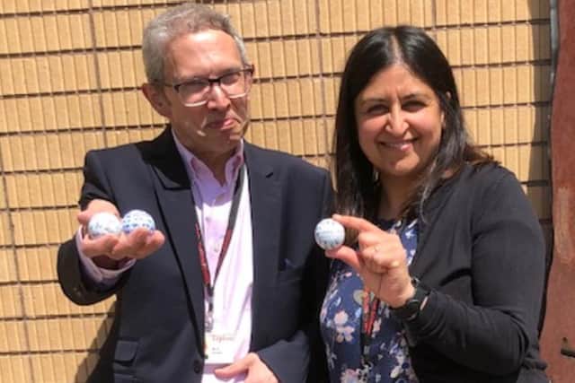 Dr Andrew Farrell, Matt Fitzpatrick's former English teacher, and Harkiran Grewal, his former history teacher,  with the golf balls the US Open winner signed for them when he left school.