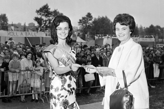 Miss Dunbar presents the 'Find the Ball' prize to Mrs Joyce Ramsay at the Round Table Fair in August 1965.