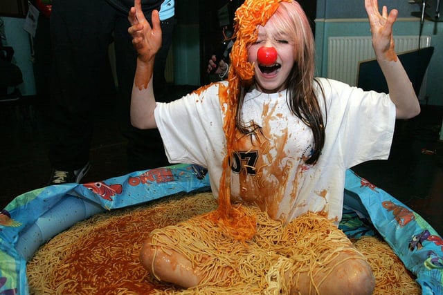 Shannon Handside sits in a pool of spaghetti for Red Nose Day.