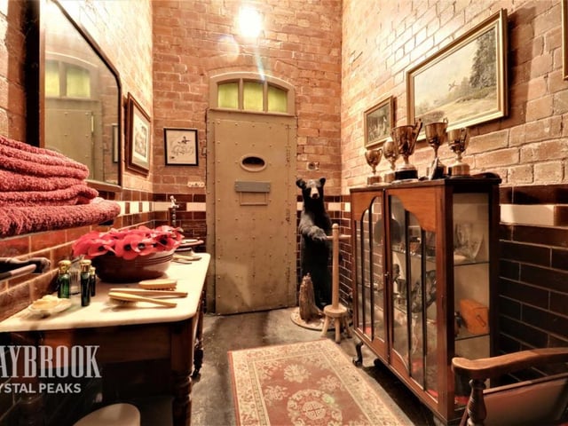 With a rug and furniture, this former cell is looking far more like a room you might want to stay in.