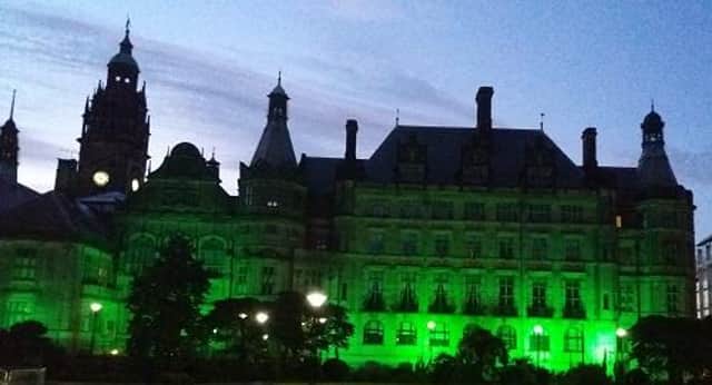 The Town Hall lit up in green.