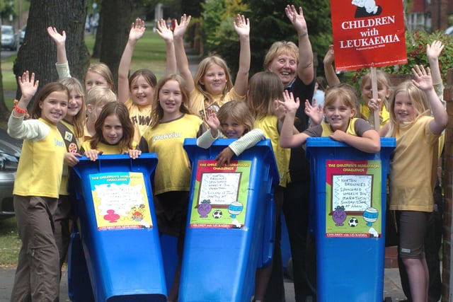 Members of the 148th Sheffield (St James) Brownies prepare to set off on a sponsored Wheelie Bin Marathon in aid of Children with Leukaemia in 2004