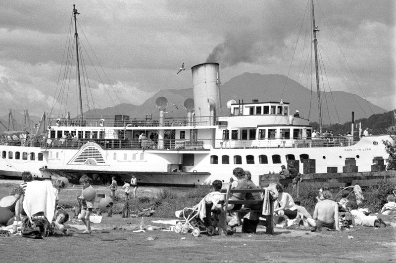 Balloch has been a long-time favourite for Glaswegians too - pictured here are holidaymakers enjoying the sun in Balloch as the Maid of the Forth paddle steamer passes by in Loch Lomond, July 1972