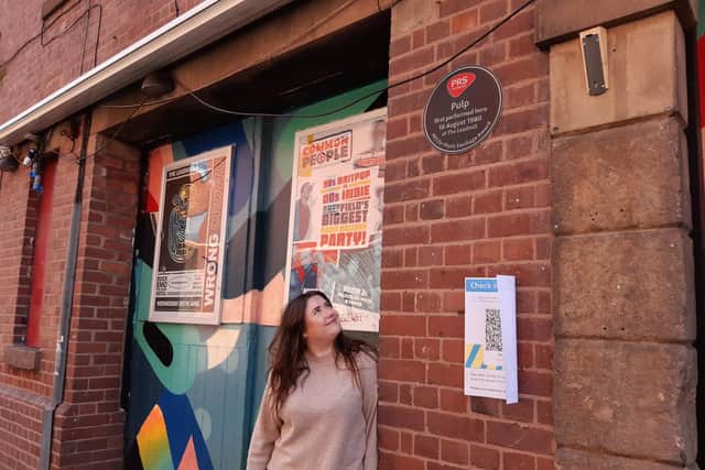 Rose Wilcox and a sign that says: 'Pulp first performed here 16 August 1980 at The Leadmill'