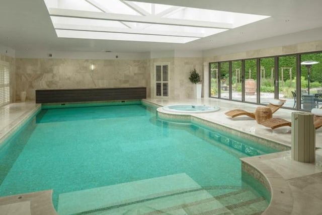 Enjoy a dip in this impressive swimming pool which forms part of the property's leisure suite with a Jacuzzi, steam room, sauna and changing room. 
A vaulted roof lantern adds glorious brightness with windows overlooking the side garden. Image by Rightmove.
