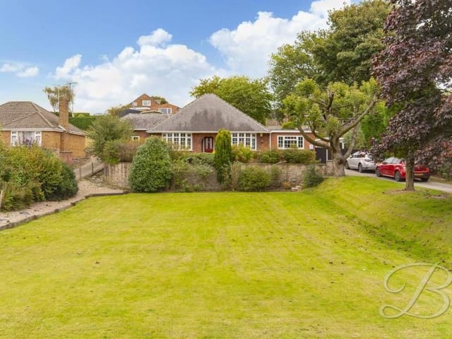 A view of the exterior of the Big Barn Lane bungalow from the back. It shows that the property sits in a delightful setting.