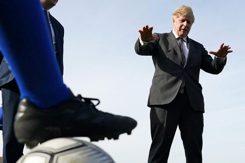 Britain's Prime Minister Boris Johnson gestures during a visit to Hartlepool United Football Club as he campaigns on behalf of Conservative Party candidate Jill Mortimer in Hartlepool, north-east England on April 23, 2021, ahead of the 2021 Hartlepool by-election to be held on May 6.
