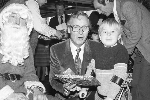 Another famous visitor was Nicholas Parsons and here he is helping youngsters to have a wonderful time at the 1983 party in the Joplings restaurant.