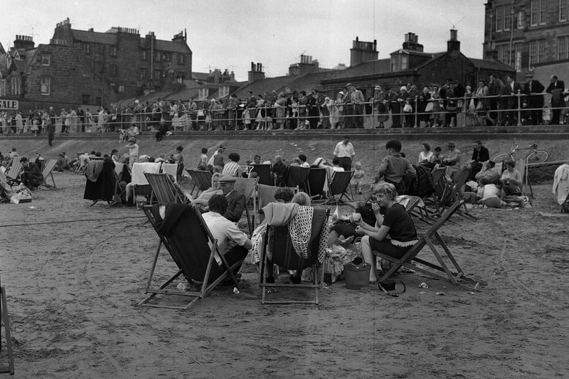Glasgow Fair holiday-makers sunbathe on deckchairs on Portobello Beach.