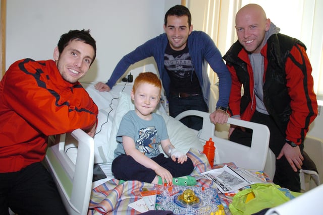 Brian Stock, Sam Hird and James O'Connor help five-year-old Owen Carey of Sprotbrough with his new game during Christmas 2011