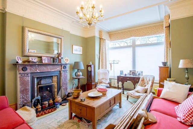 The property's three reception rooms all have bay windows and cosy fireplaces.