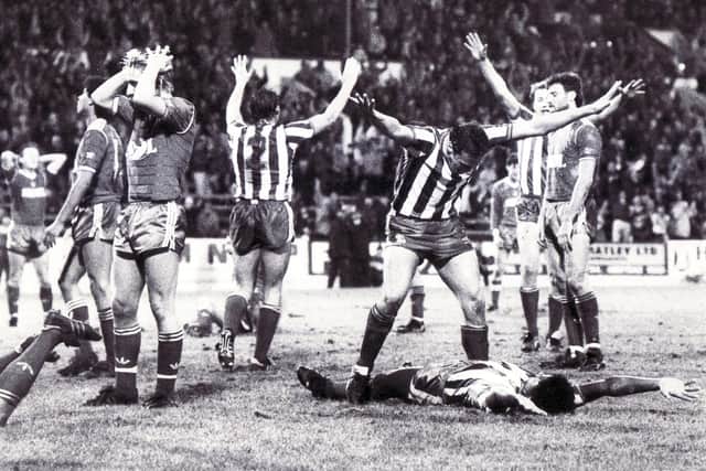 Sheffield Wednesday v Nottingham Forest - 7th December 1985 - Chamberlain lying on the turf is congratulated by team mate Gary Shelton after scoring Wednesday's second goal.