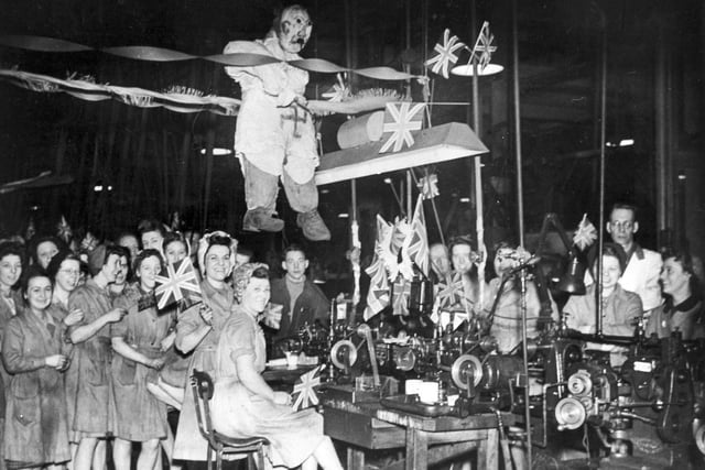 Hitler 'hangs out' amid the festivities in the Thomas Firth and John Brown engineers' tool room, dominated by the female workforce, in May 1945