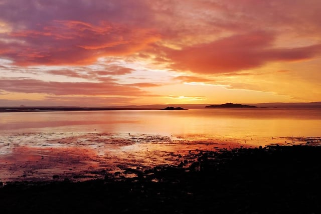 The sky cast its picturesque and delicate colours of pink, yellow and orange across this Fife beach's seascape.