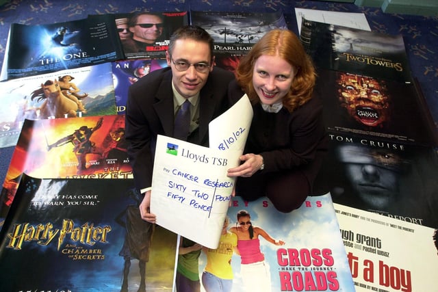 Virginia Rollitt-Smith, shop manager at Cancer Research UK's Scott Lane, Doncaster branch, is presented with a cheque for just over £60 by Odeon Cinema general manager Kenny Rice in 2002
