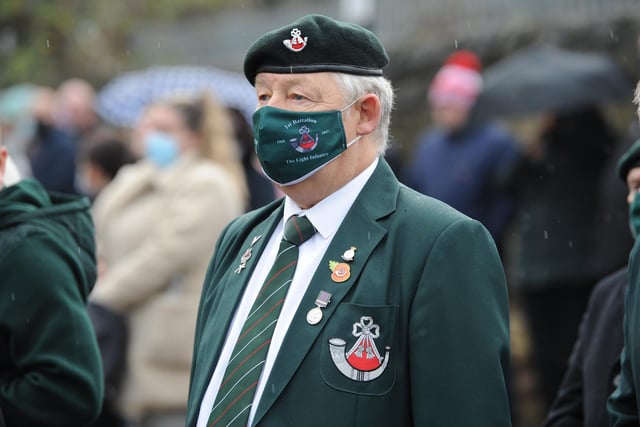 A veteran wears a mask while paying his respects in Sunderland.