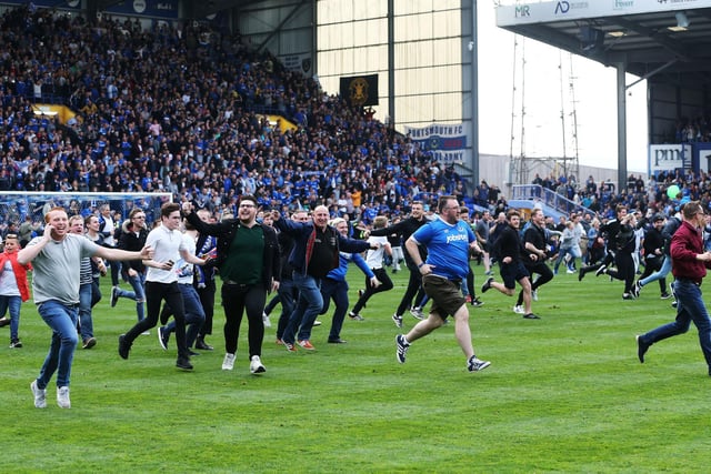 Fans invade the Fratton Park pitch.