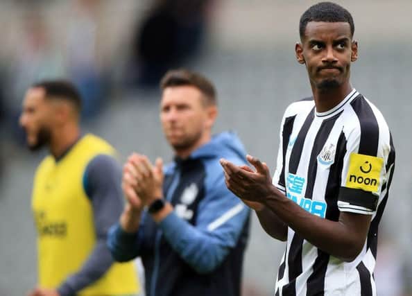 Newcastle United's Swedish striker Alexander Isak (R) applauds the fans following the English Premier League football match between Newcastle United and AFC Bournemouth at St James' Park in Newcastle-upon-Tyne, north east England on September 17, 2022.  (Photo by LINDSEY PARNABY/AFP via Getty Images)