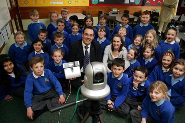 Dave Kynman, group sales director for Reflex, and Year 3 teacher Joanne Gilson with the Y3 class at Auckley Junior and Infants School, Doncaster, this week. Dave Kynman was visited the school to demonstrate the latest electronic security technologies as part of National Science Week in 2004