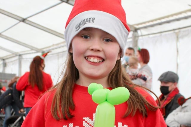 Wearing her Christmas hat, sporting her 'Happy Holidays' jumper and holding her party balloon, this girl couldn't be happier.