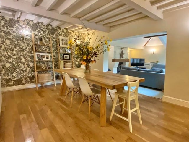 The first room we look at is the dining room. With exposed beams, oak flooring, wall lights and an open archway window to the family room, there is ample space for a large dining table.
