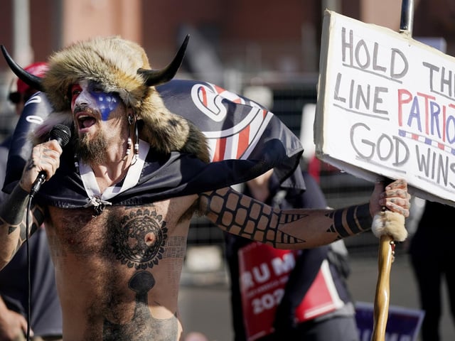 Jake Angeli, a supporter of President Donald Trump, speaks at a rally outside the Maricopa County Recorder's Office (AP Photo/Ross D. Franklin)