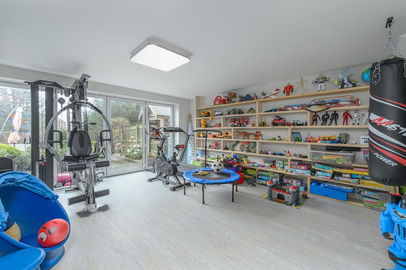 The ground floor also comprises a gym/playroom adjoining the living area which is accessed via a secret door and garage connected to the east elevation of the property.
