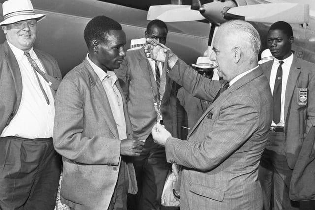 Kenyan boxer Philip Waruinge shows the gold medal he won for the Featherwight Boxing contest at the Commonwealth Games in Kingston, Jamaica, at Turnhouse Airport in August 1966.