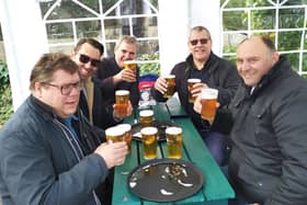 Drinkers raise a glass at the Stags Head in a gazebo in the beer garden.