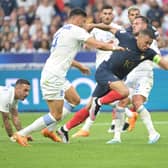 France's forward Kylian Mbappe (R) is challenged by Greece's defender Konstantinos Mavropanos (L) and Greece's Sheffield United defender George Baldock (R) during the UEFA Euro 2024 group B qualification football match between France and Greece at the Stade de France in Saint-Denis: ALAIN JOCARD/AFP via Getty Images