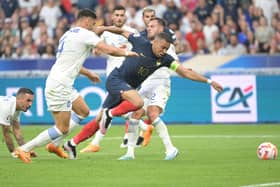 France's forward Kylian Mbappe (R) is challenged by Greece's defender Konstantinos Mavropanos (L) and Greece's Sheffield United defender George Baldock (R) during the UEFA Euro 2024 group B qualification football match between France and Greece at the Stade de France in Saint-Denis: ALAIN JOCARD/AFP via Getty Images