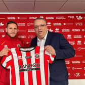 Billy Sharp presents the charity CEO with the first tribute shirt