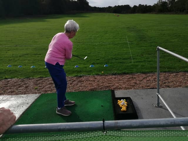 Sheffcare resident Wendy is practicing her swing at Hillsborough Golf Club