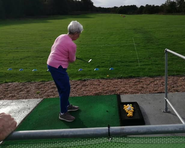 Sheffcare resident Wendy is practicing her swing at Hillsborough Golf Club