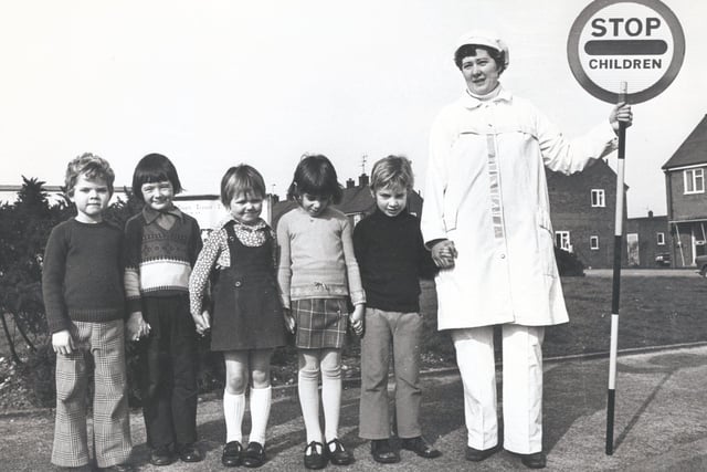 Crossing warden with her new uniform Judith Vickers with children, John Vickers, Simon Gilbert, Eva Wainwright, Susannah Haw and Stuart Slack, February 1976