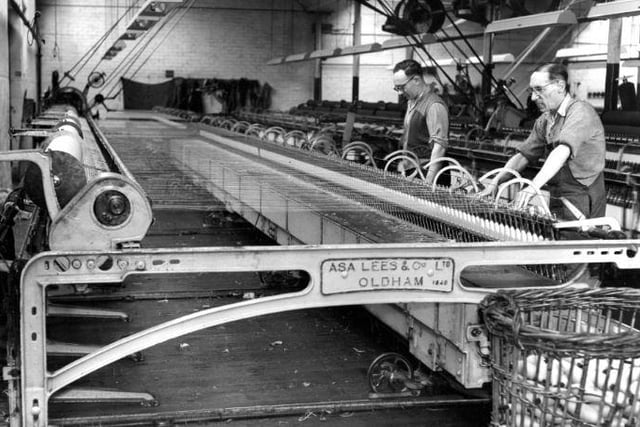 George Roberts & Co Ltd, tweed mill, August 1962. Operator changing bobbins on carding machine.